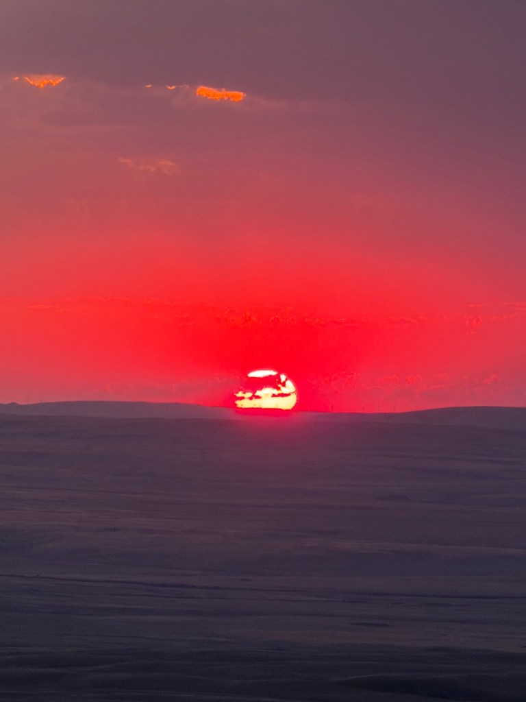 sun disappearing on the horizon Bald Butte, Cypress Hills, Saskatchewan