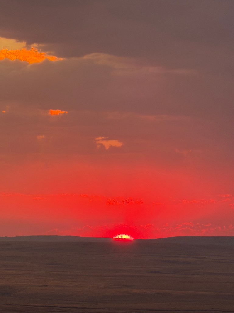 sun disappearing on the horizon Bald Butte, Cypress Hills, Saskatchewan