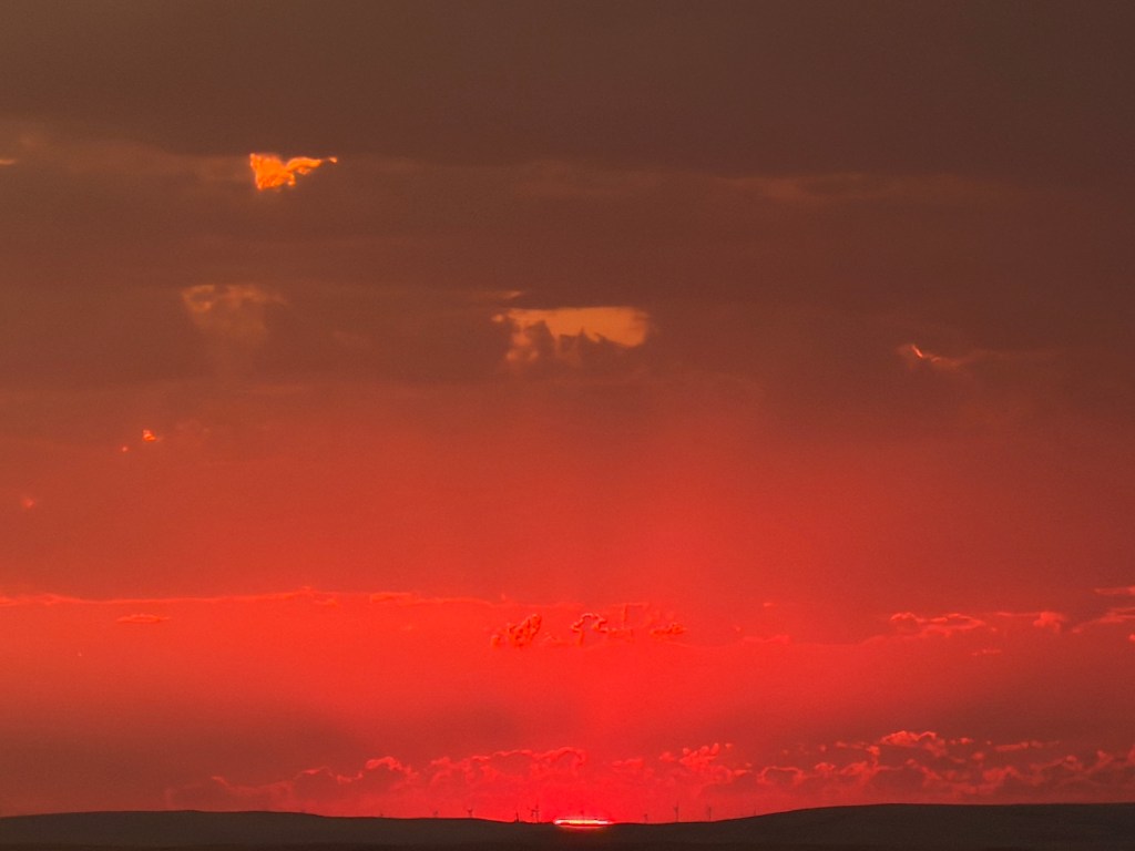 sun disappearing on the horizon Bald Butte, Cypress Hills, Saskatchewan